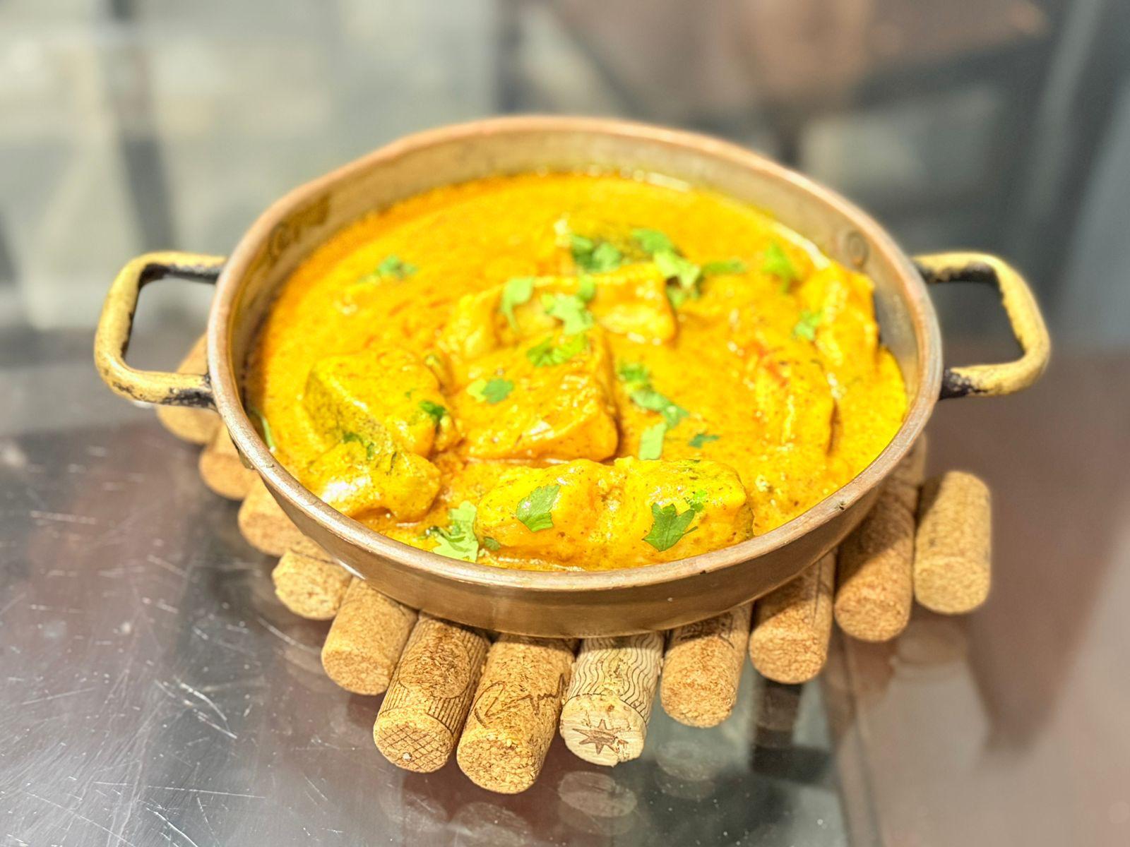 Portuguese seafood curry in traditional clay pot