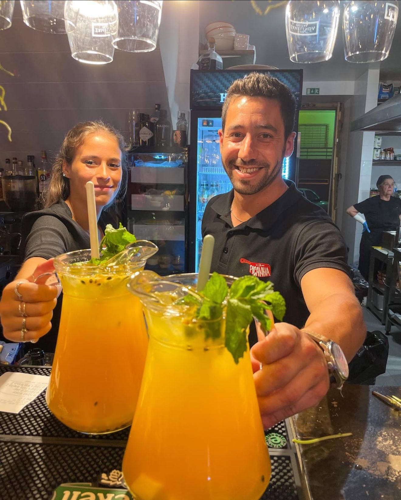 Bartenders serving fresh passion fruit cocktails