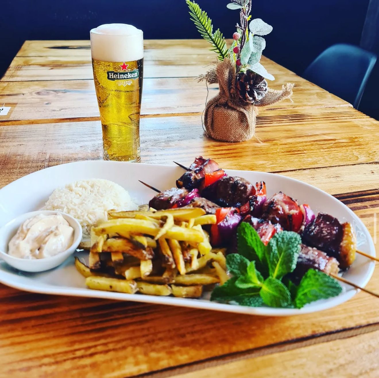 Grilled meat skewers with beer and sides
